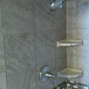 Shower tile with glass accent strip.