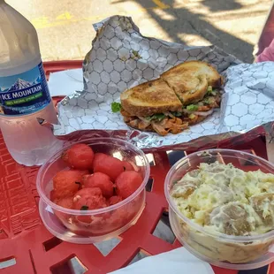 Refreshing watermelon salad, potato salad, and buffalo chikn sandwich.