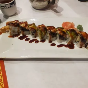 a plate of sushi with sauce