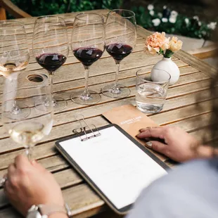 a table with wine glasses and a menu