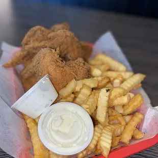 a basket of fried chicken and fries
