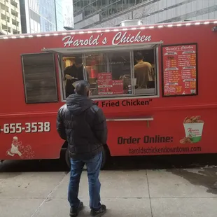 a man standing in front of a food truck