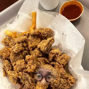 a tray of fried chicken and fries