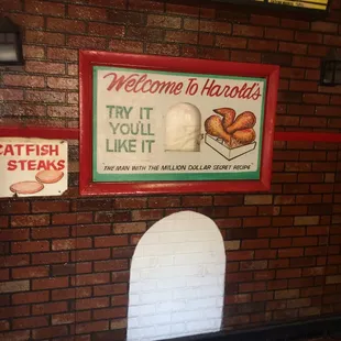 a brick wall with a sign that reads welcome to harold&apos;s try it you like it