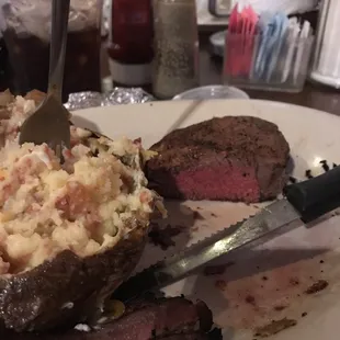 Perfectly cooked filet with a baked potato.