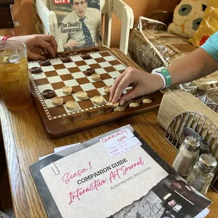 Bored? Four shelves of board games to enjoy before or after dining.