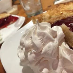 a slice of pie with whipped cream