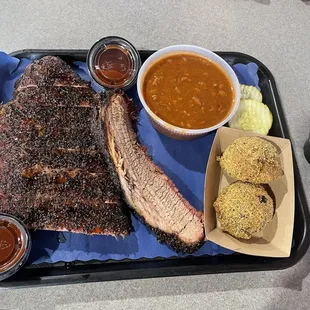 Half a rack of ribs and brisket, boudin balls, and baked beans