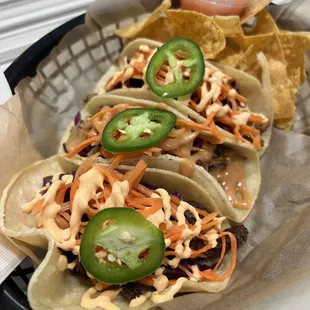 a basket of tacos and chips