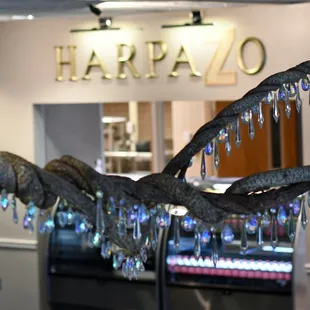 a branch of a tree with blue crystals hanging from it