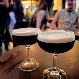 two glasses of beer on a bar