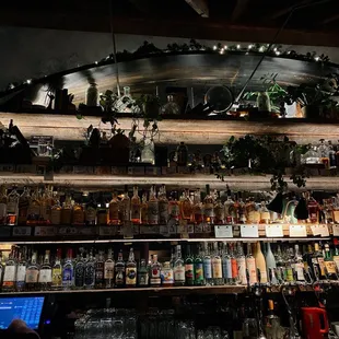 a bar with a lot of bottles on the shelves