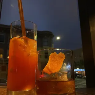 two glasses of drinks on a table