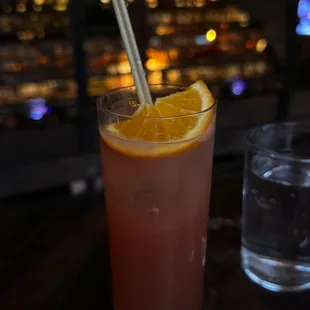 a drink with a straw and a slice of orange