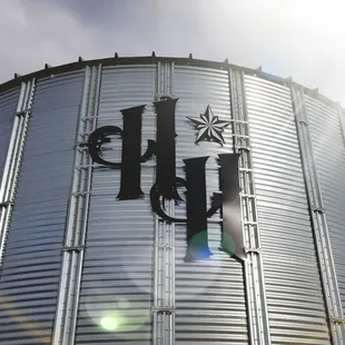a metal silo with the letter h on it