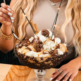 a woman eating a chocolate sundae