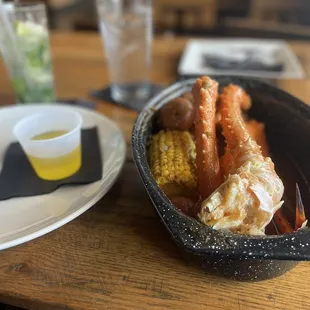King crab legs, sausage, and corn in Old Bay broth