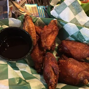 a basket of fried wings and dipping sauce