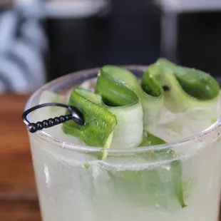 a cocktail with cucumber and mint