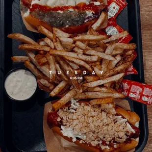 Beef hot dogs on brioche buns with a side of fries.