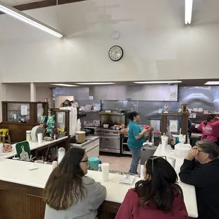 a group of people in a kitchen