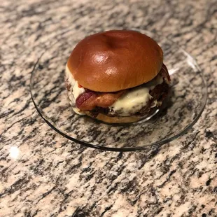 a hamburger on a glass plate