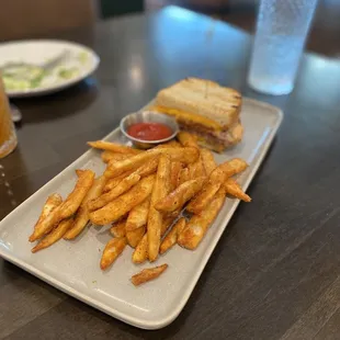 Randys patty melt cut in half served on two different plates fries are FIRE!!!!!