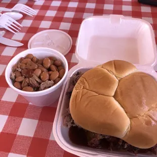 Brisket sandwich with small side of beans