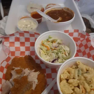 Catfish with coleslaw, macaroni salad and beans.