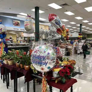 a table with balloons and flowers