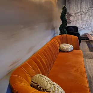 a living room with orange couches