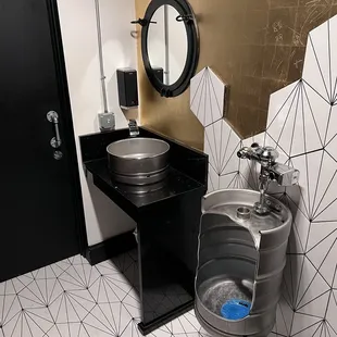 a urinal and sink in a public restroom