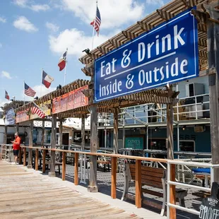 a dock with a sign that says eat drink inside and outside