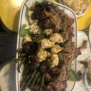 a platter of meat and vegetables