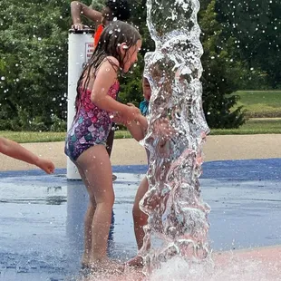 The dumping bucket catches Emily at the Harry Myers Splash pad.