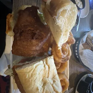 Giant fish sandwich with homemade tartar sauce and onion rings for any room left in your belly!