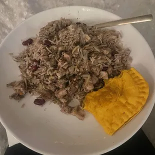 Jerk chicken with red beans and rice and a Jamaican meat patty