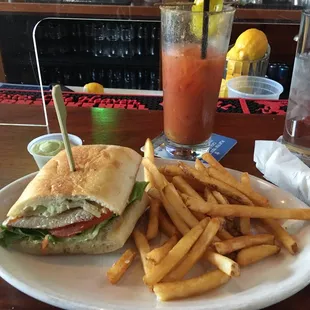 Our fried chicken sandwich and fries split in advance w the Bloody Mary.