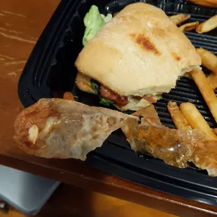 Fried pieces of wax paper pulled from chicken sandwich.