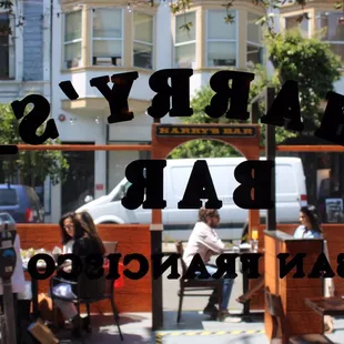 people sitting at tables outside