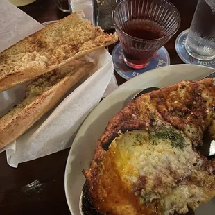 Lasagna, Manhattan and bread.