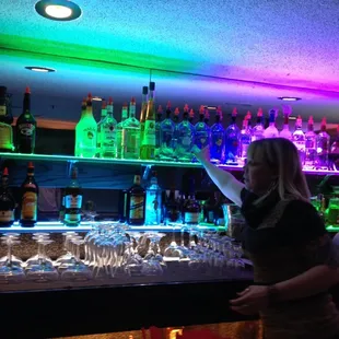 a woman standing at a bar