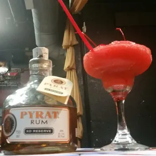 a glass of rum and a bottle of rum