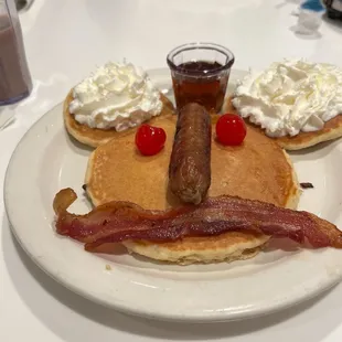 Pancakes with sausage, bacon, cherries, syrup and whipped cream...yummy!