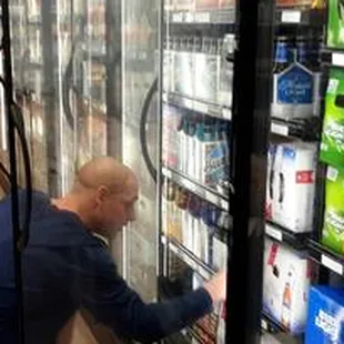 a man looking into a refrigerator