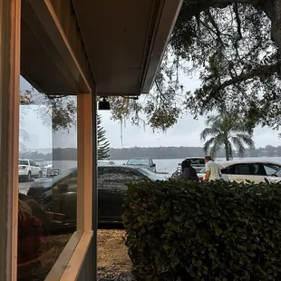 Outdoor dining and a section of restaurant has view of lake.