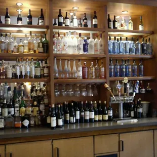 shelves of alcohol bottles and glasses