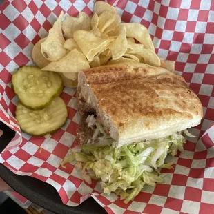 Half a large cheeseburger sub with chips