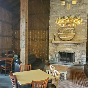 a stone fireplace and seating area