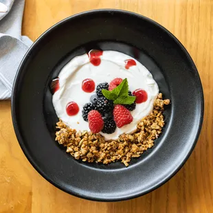 Yogurt Parfait: low fat Greek yogurt, house made granola, raspberry coulis, fresh berries